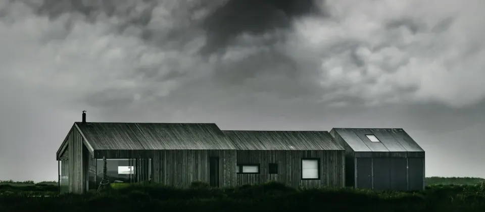 Timber clad house beside a river