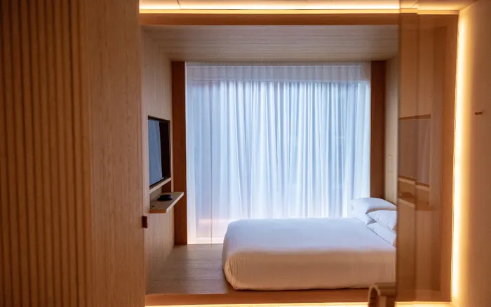 A warm timber lined bedroom